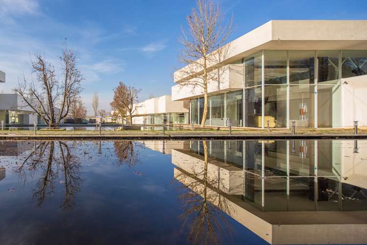 Daylight reflected in the project's water beside the pavilion